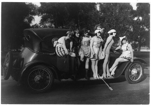 Siete bellezas bañistas de Mack Sennett de pie alrededor de un coche. 